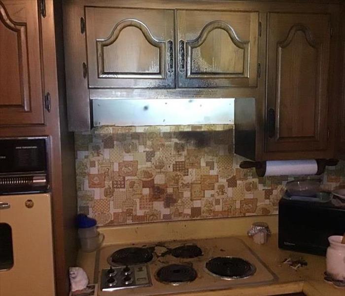 A kitchen range that has turned black due to a grease fire