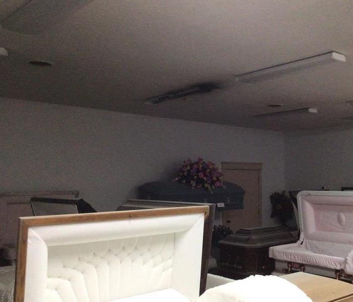 Casket room in funeral home with a light that has burned and turned black