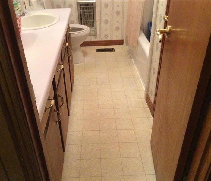 A bathroom that has water damage, a shower, sink and toilet are shown